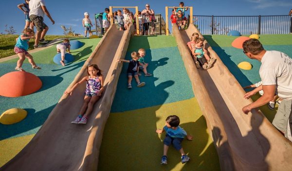 Children on outdoor slides and play area