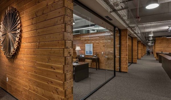 Darker finished wooden walls in office interior with lower lighting levels at Weyerhaeuser Corporate Offices Seattle.