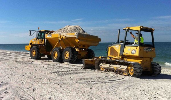 Equipment bringing sand to beach in Naples, Florida.