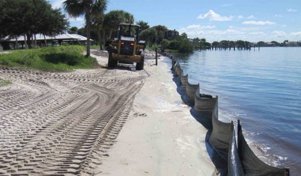 Equipment spreading sand for re-nourishment at Port Charlotte Beach