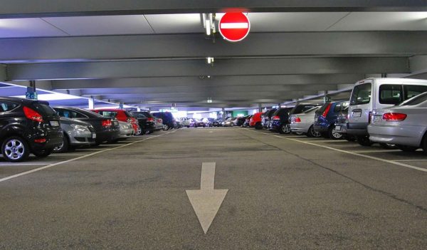 Rows of cars parked in an above ground covered parkade.