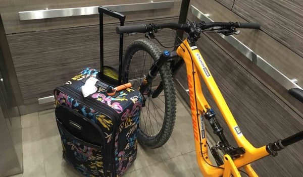 Bike and suitcase in an elevator.