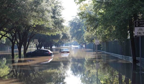Cars floating down a flooded street in Houston, Texas. 