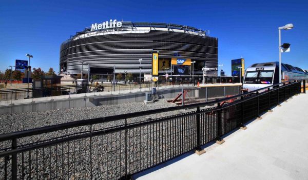 Exterior view of MetLife stadium with train and track in the forefront