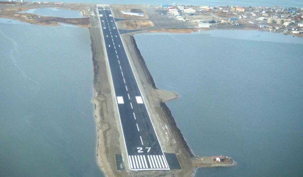 Aerial view of runway extending into the water