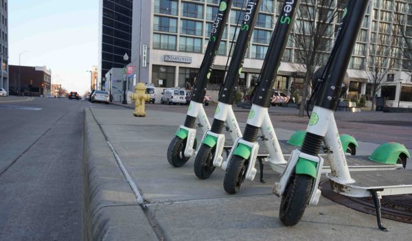 Scooters parked on the sidewalk