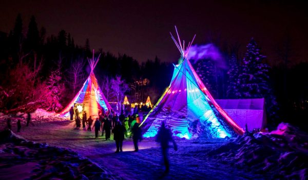 Winter festival at night with teepees lit up